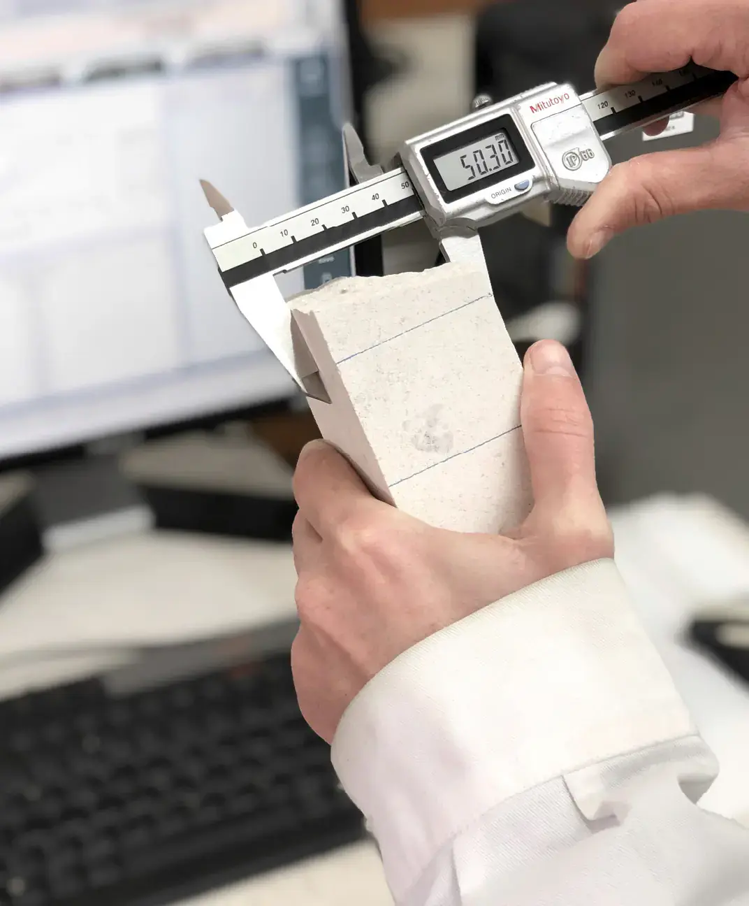 Worker measuring stone block with OnTest
